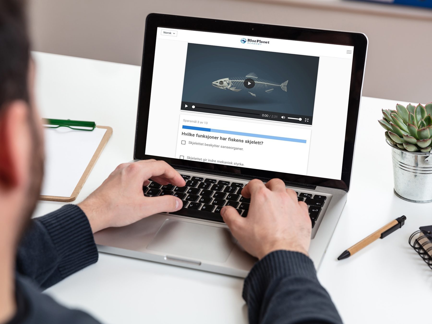 Computer screen mockup. Man working with a black blank screen laptop on a wood desk, office background, copy space